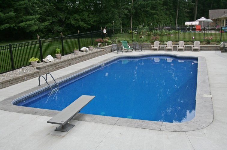 This Is A Photo Of A Patrician In Ground Pool In East Longmeadow, MA With Chairs And Fence In Backyard.