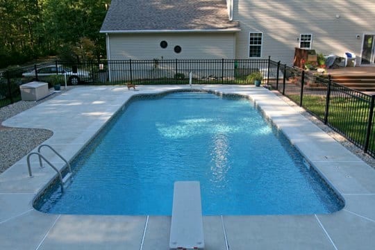 This Is A Photo Of A Patrician In Ground Pool In Montville, CT With Custom Pavers And Black Fence.