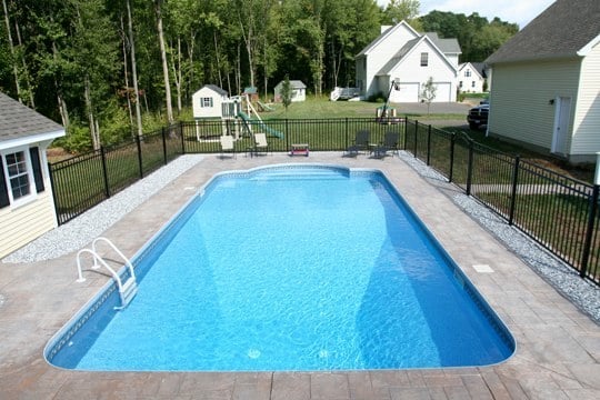 This Is A Photo Of A Patrician In Ground Pool In Suffield, CT With Custom Pavers, Black Fence And Steps.