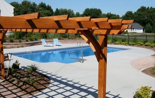 This Is A Photo Of A Custom Rectangular Inground Swimming Pool With Canopy In The Forefront.