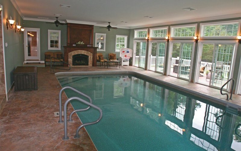 This Is A Photo Of A Custom Rectangular Inground Swimming Pool Indoors With Rounded Corners And Fireplace