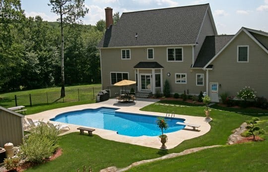 This Is A Photo Of A Roman In Ground Pool In Tolland, CT With Custom Pavers, Diving Board And Steps.