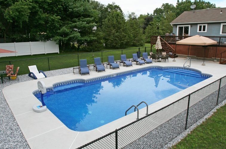This Is A Photo Of A Patrician In Ground Pool With Custom Pool House, Chairs And Deck
