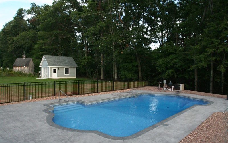 This Is A Photo Of A Roman In Ground Pool In East Longmeadow, MA With Custom Pavers, Diving Board And Steps.