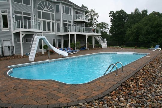 This Is A Photo Of A Roman In Ground Pool In Somers, CT With Custom Pavers And Steps.