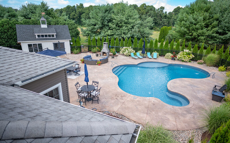 Custom Swimming Pool Built By Juliano's Pools With Swim-out And Bench, Stamped Concrete