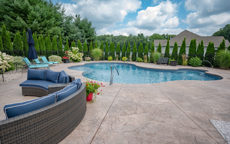 Custom Swimming Pool Built By Juliano's Pools With Swim-out And Bench, Stamped Concrete