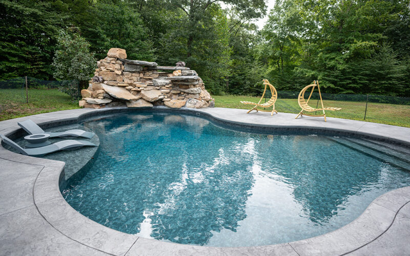 Custom Swimming Pool Built By Juliano's Pools With Swim-out And Stamped Concrete Patio